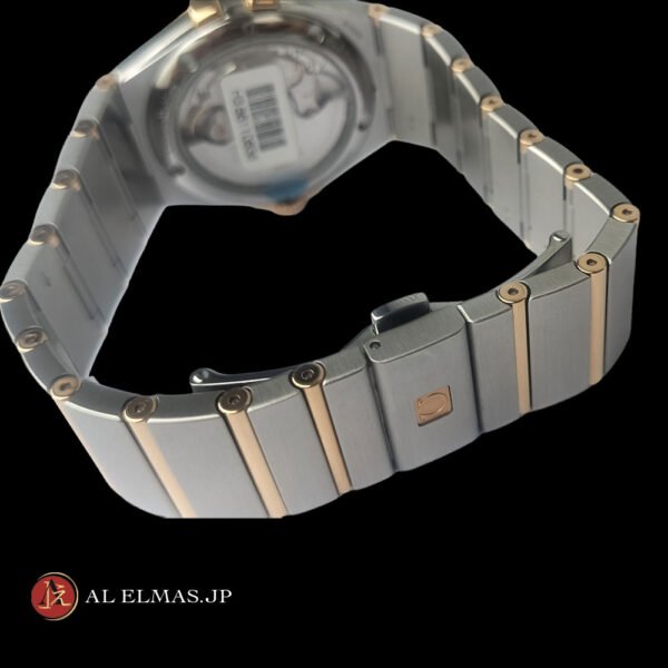 Omega Constellation Co-Axial Chronometer watch with black textured dial, rose gold bezel, date display, and stainless steel and rose gold integrated bracelet.